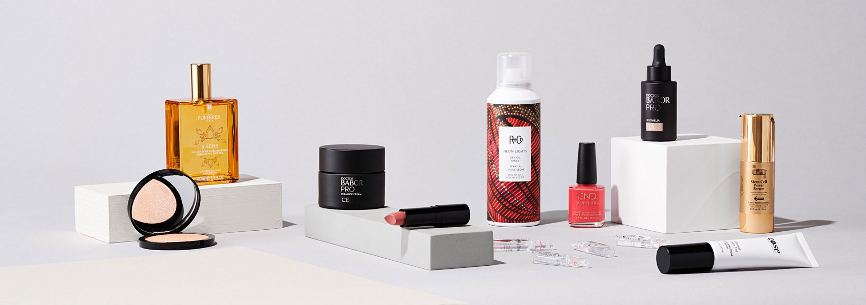 Selection of ten beauty products displayed cleanly on bright, neutral set
