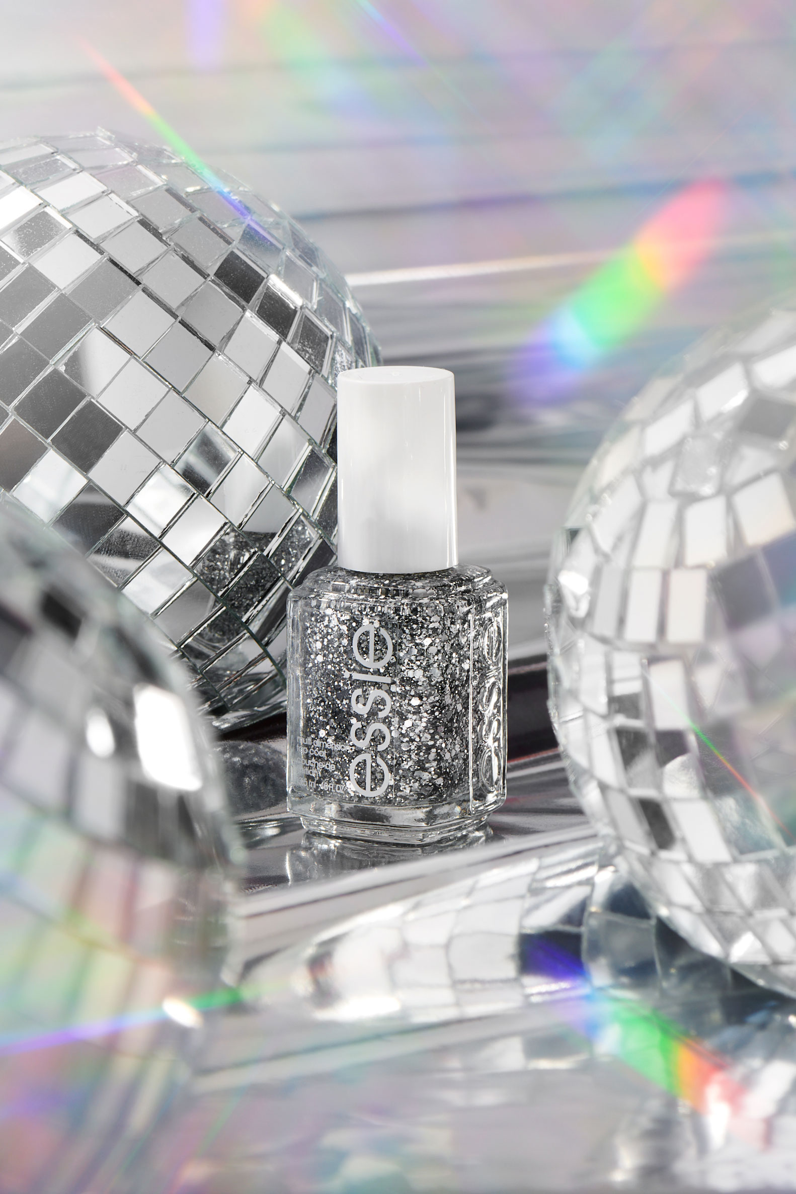 Silver glitter essie brand nail polish bottle with disco balls