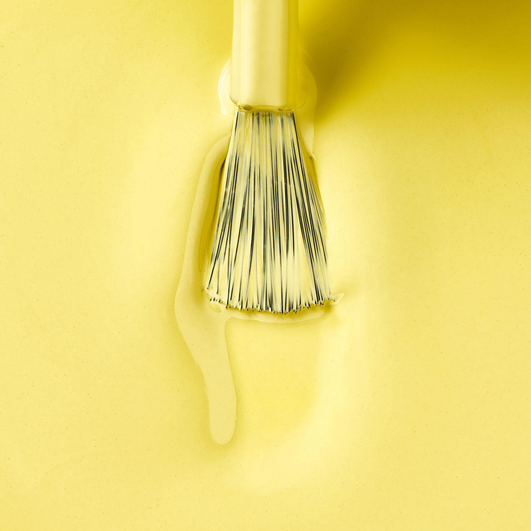 Yellow nail polish texture with applicator brush