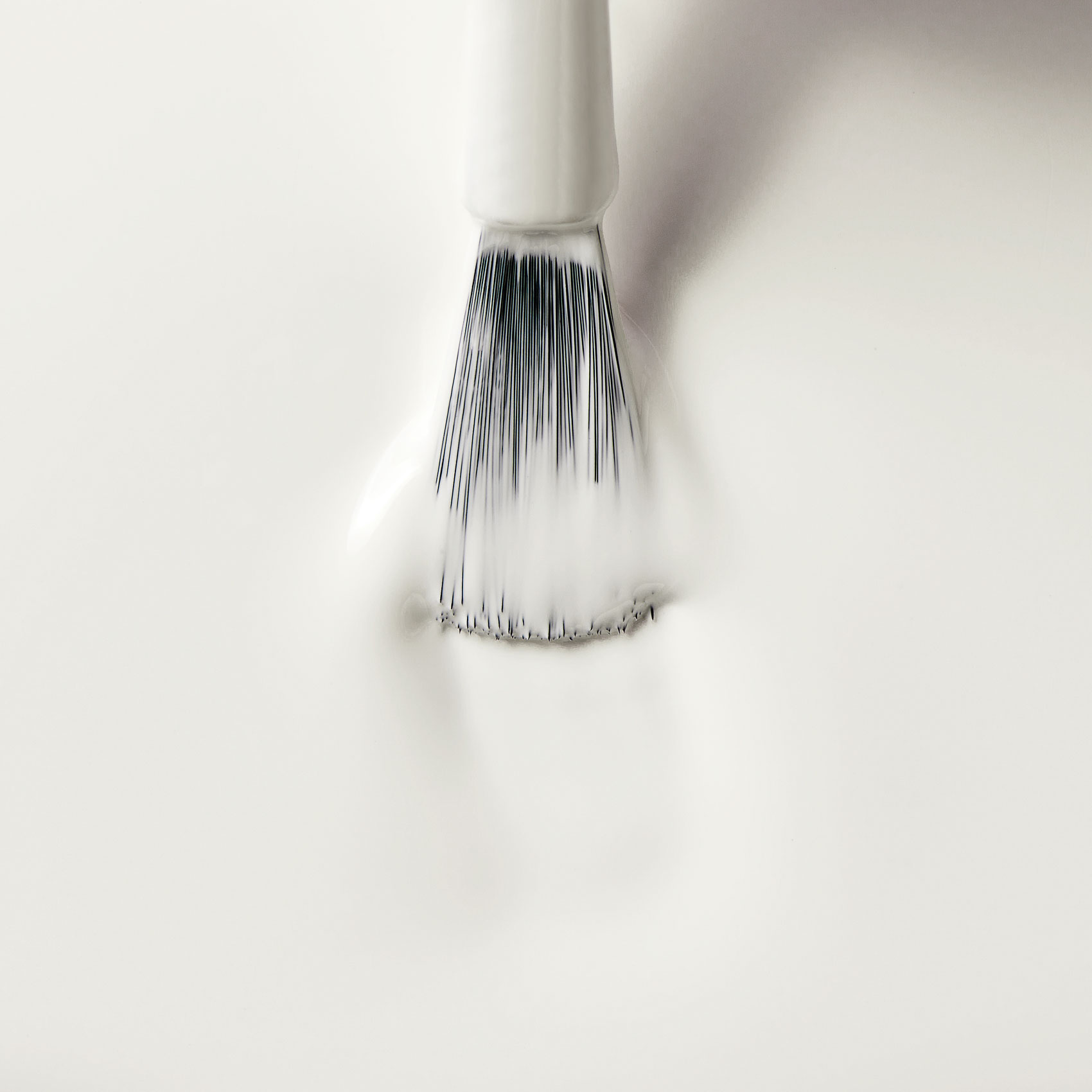 White nail polish texture with applicator brush