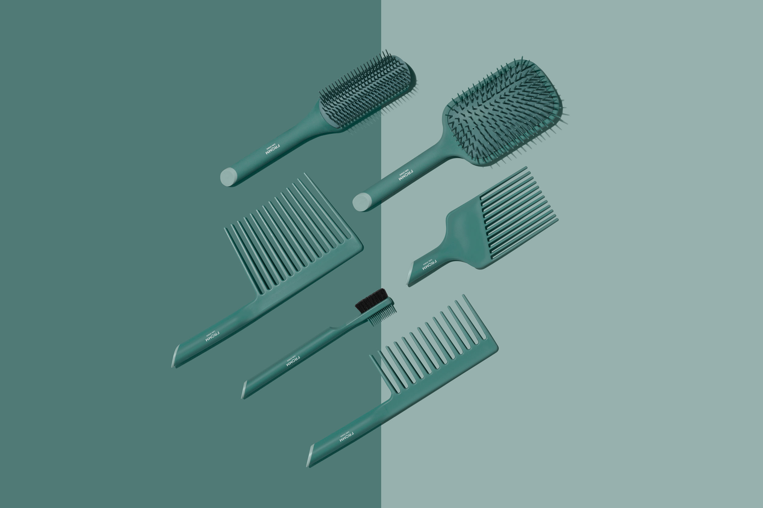 Collection of green brushes and combs arranged flat with two-tone background