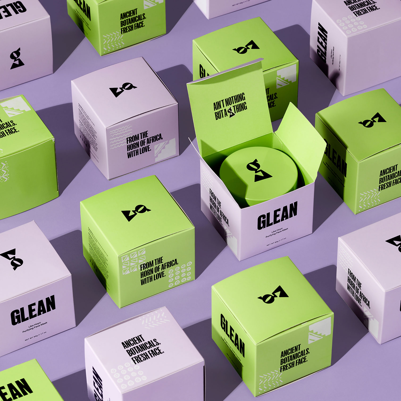 Purple and green skincare product packaging styled neatly in alternating pattern