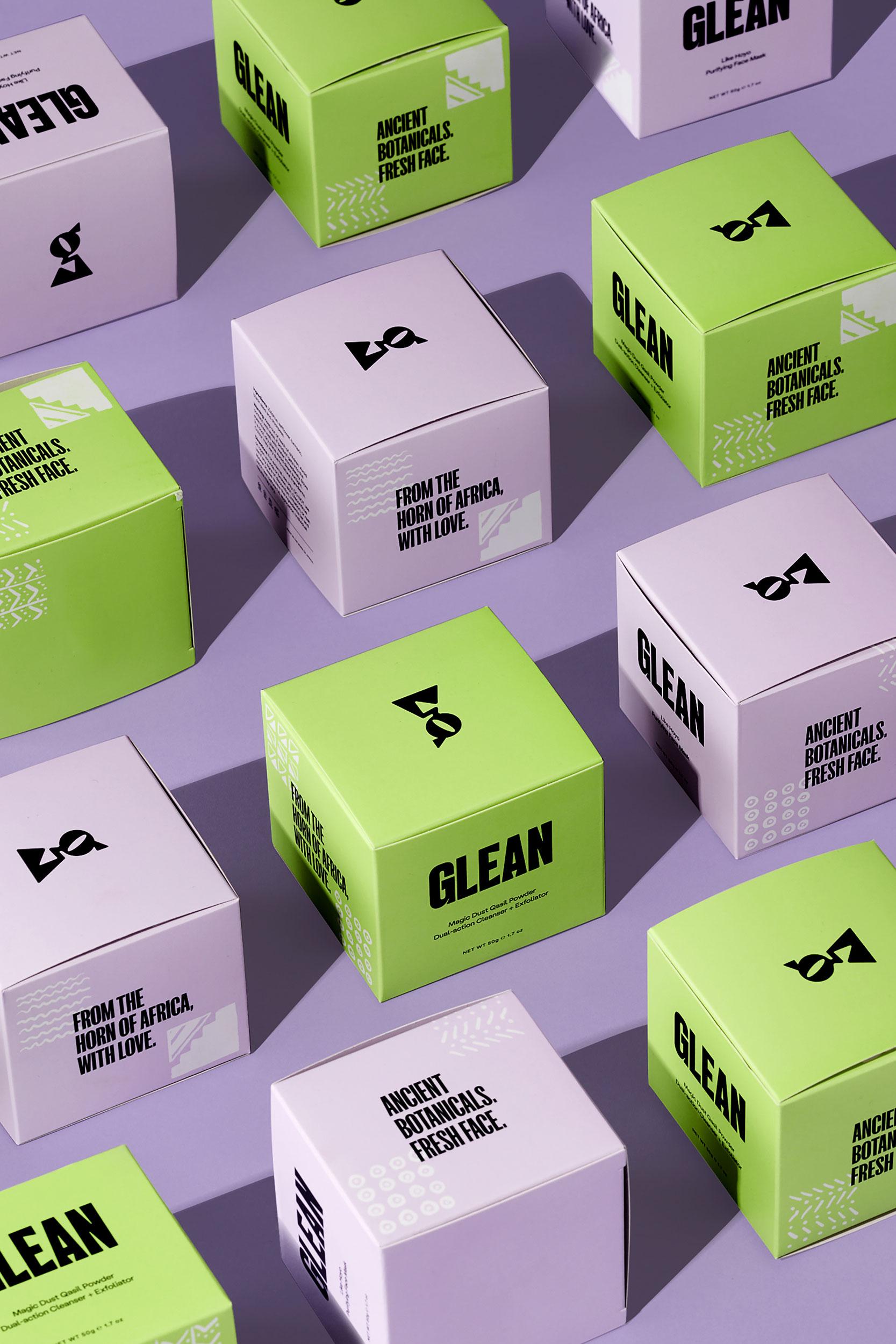 Vertical image of purple and green skincare product packaging styled neatly in alternating pattern
