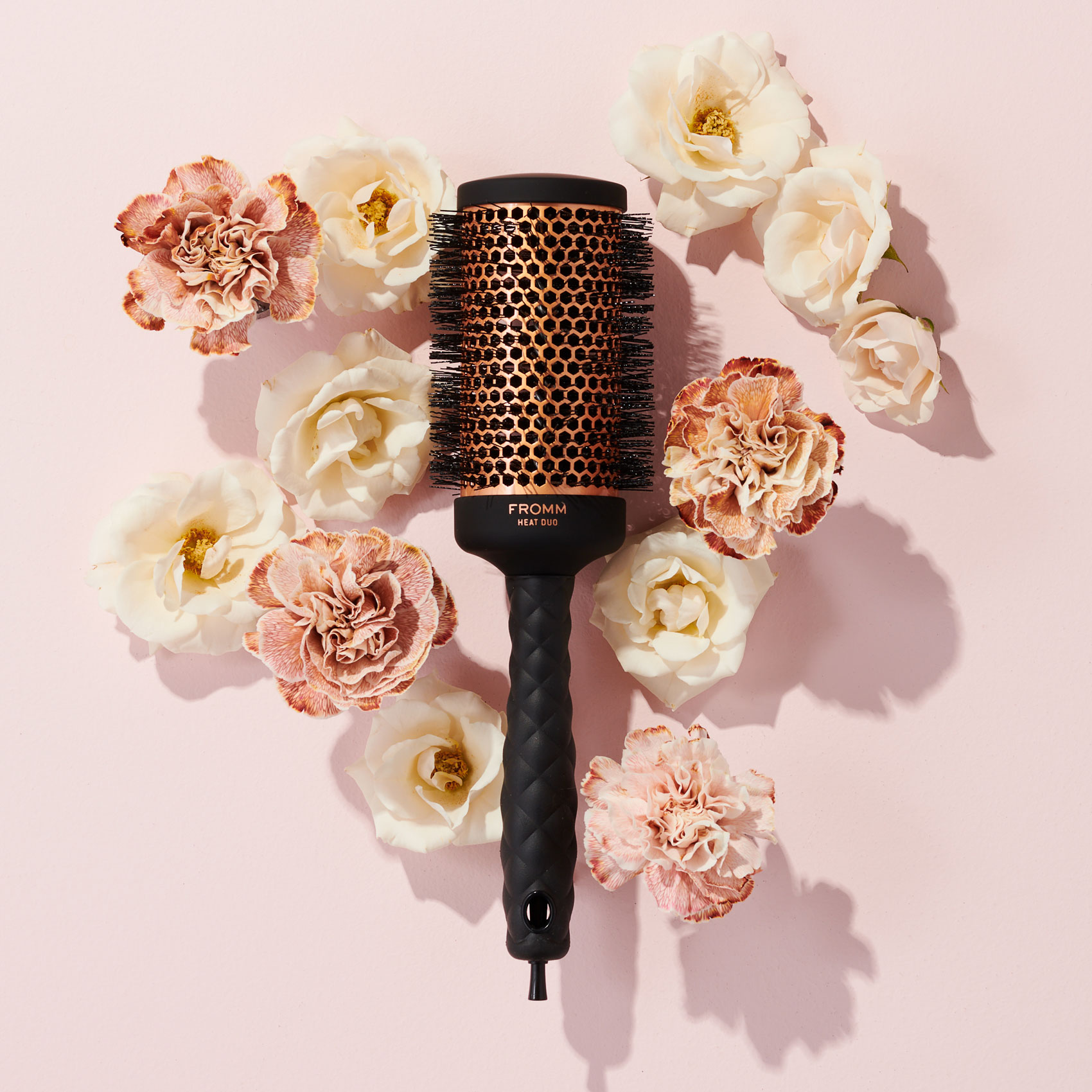 Copper thermal round brush surrounded by florals