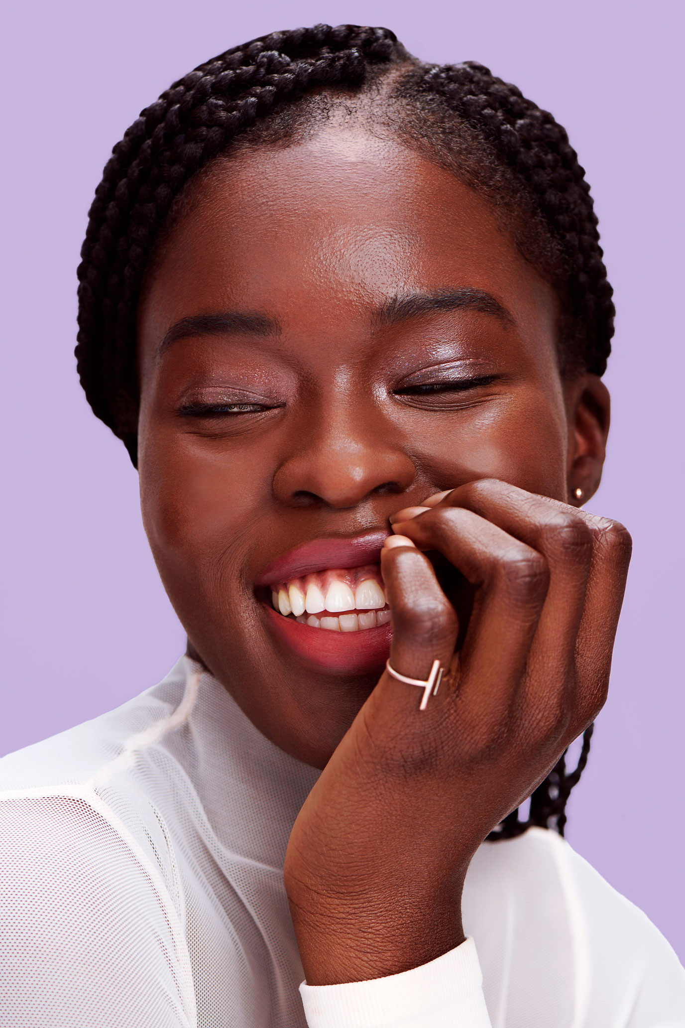 Tight portrait of Black female model with purple background