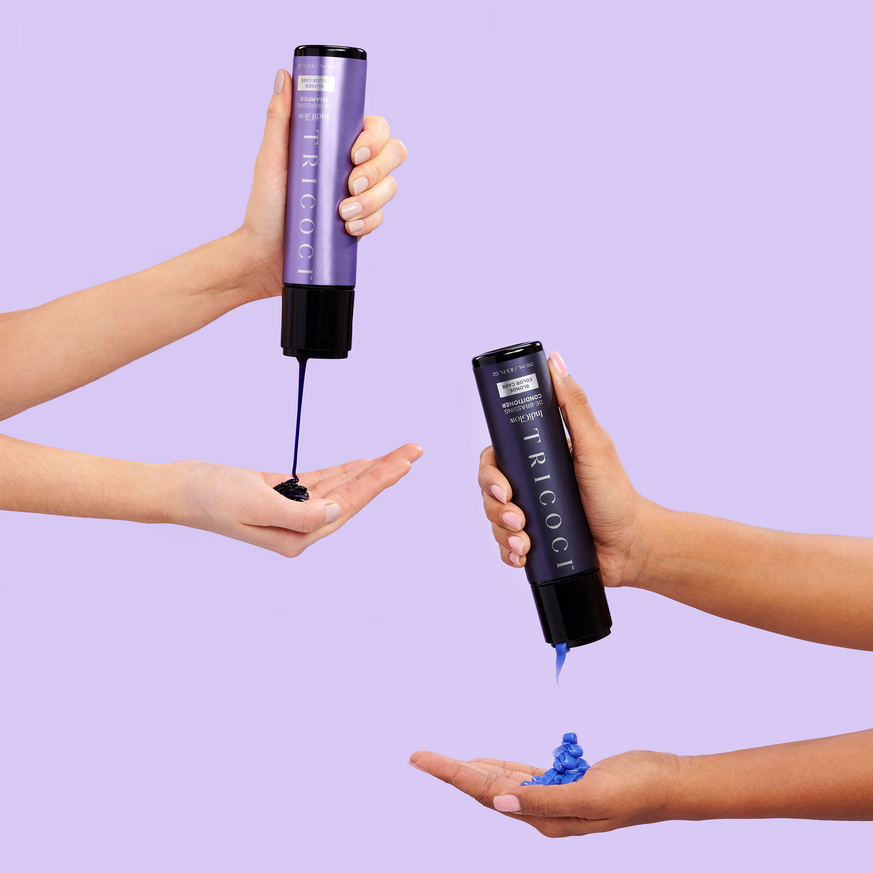Two sets of female hands squeezing and holding haircare products