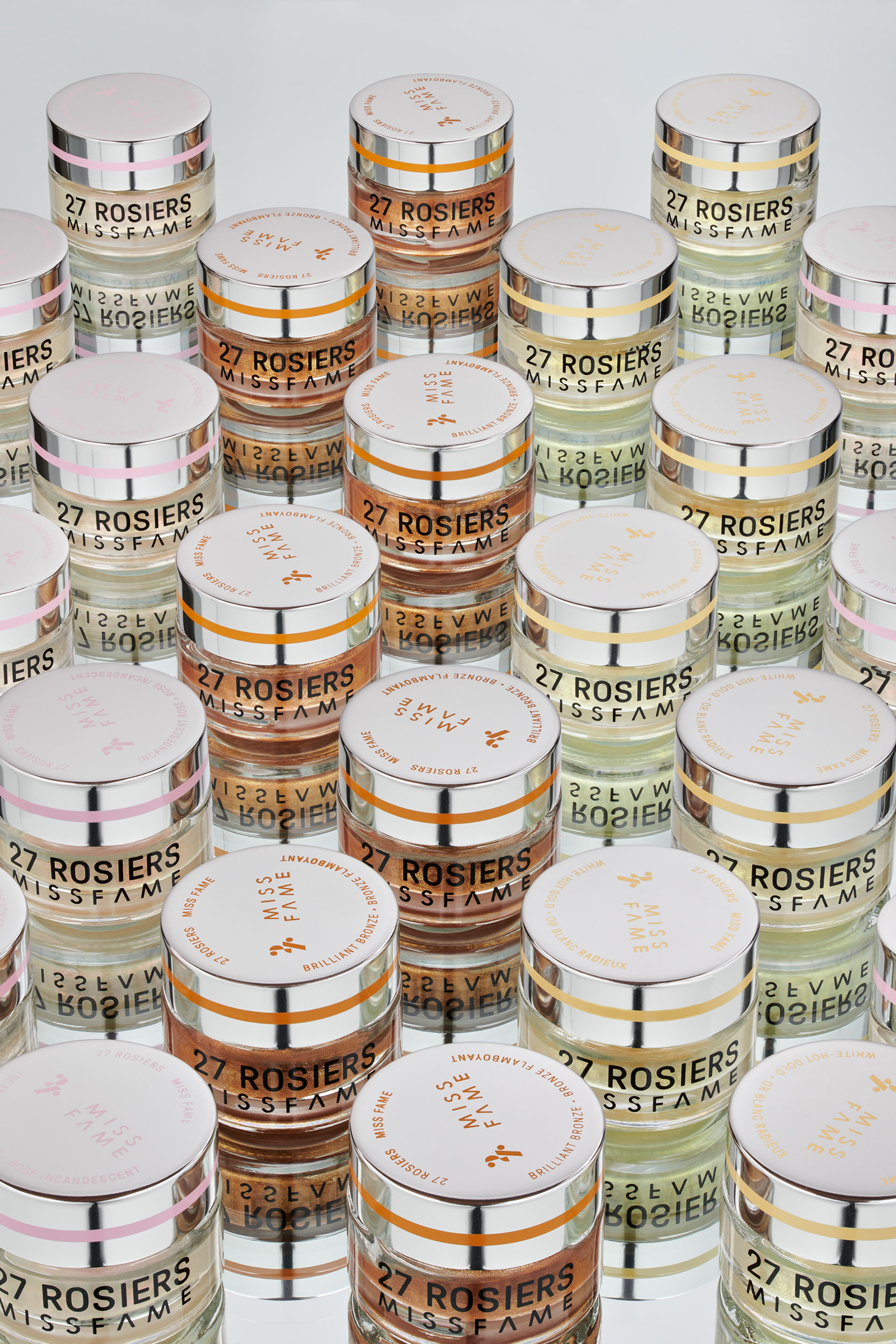 Cosmetic product containers styled in uniformed pattern on mirrored surface